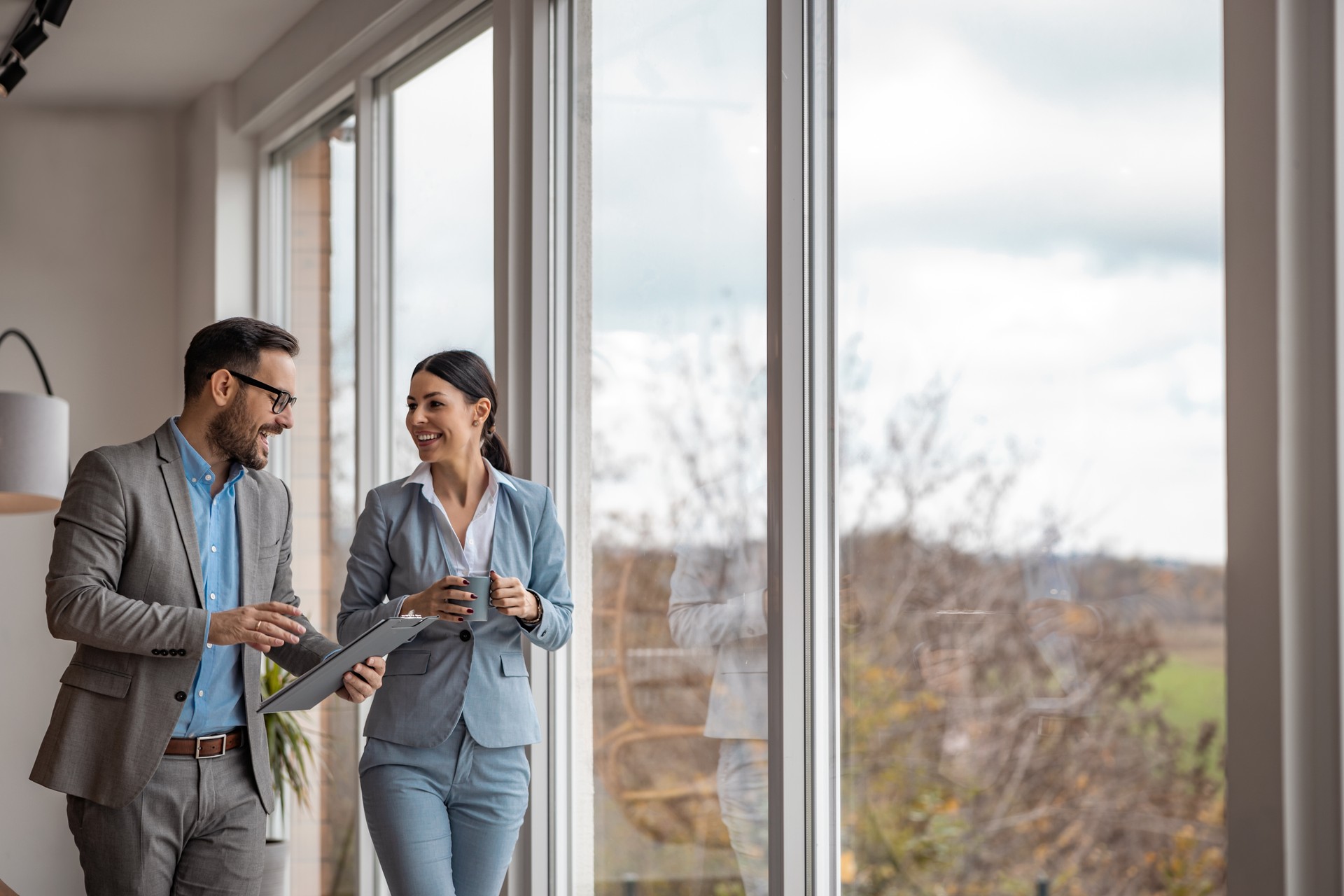 Real estate agent with woman closing a deal and signing a contract